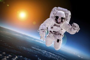Astronaut in outer space against the backdrop of the planet earth. Elements of this image furnished by NASA.