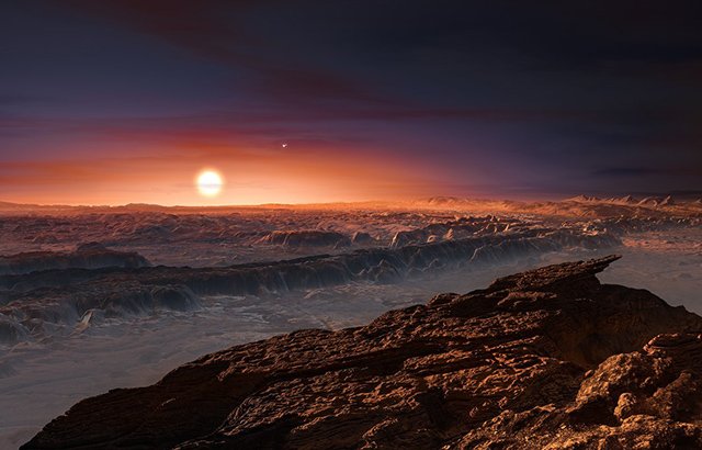 This artist’s impression shows a view of the surface of the planet Proxima b orbiting the red dwarf star Proxima Centauri, the closest star to the Solar System. The double star Alpha Centauri AB also appears in the image to the upper-right of Proxima itself. Proxima b is a little more massive than the Earth and orbits in the habitable zone around Proxima Centauri, where the temperature is suitable for liquid water to exist on its surface.